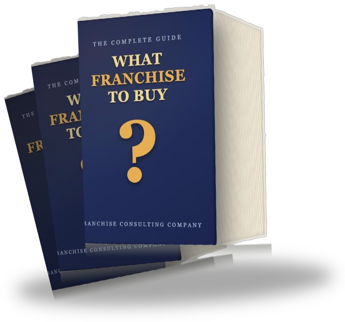 Stack of three hardback copies of the What Franchise To Buy guide, one standing upright showing the full navy cover with gold question mark, two more copies fanned behind it